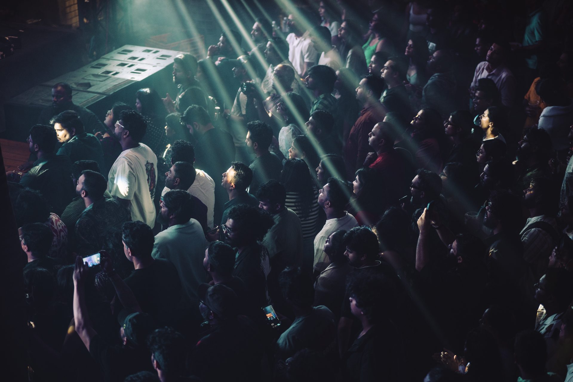Concert crowd with dramatic light rays — IMP Events Hyderabad