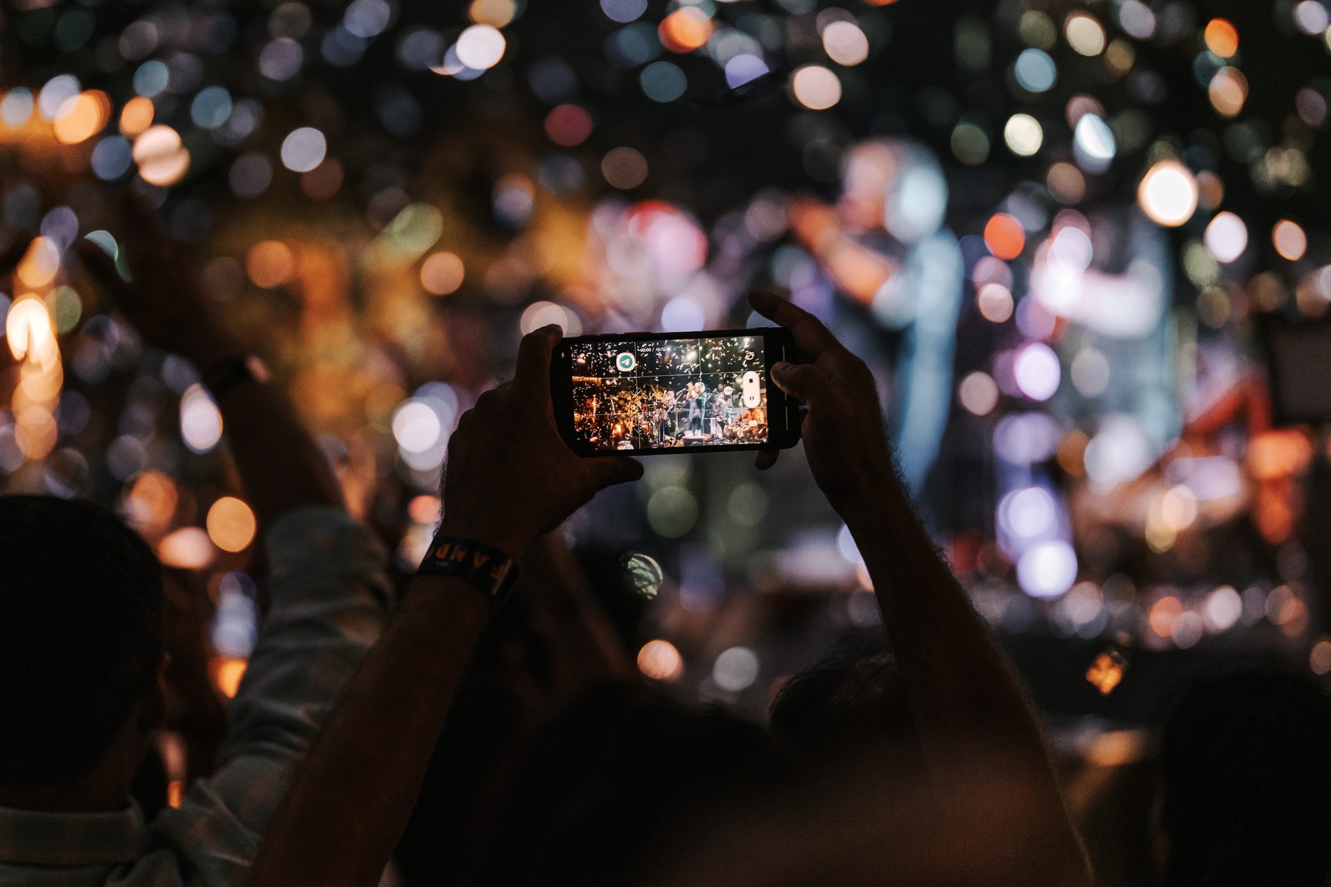 Audience filming live performance — IMP Events
